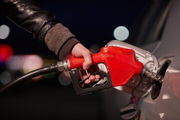 Fuel station nozzle filling car tank