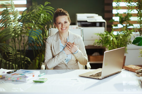 smiling business owner woman in green office
