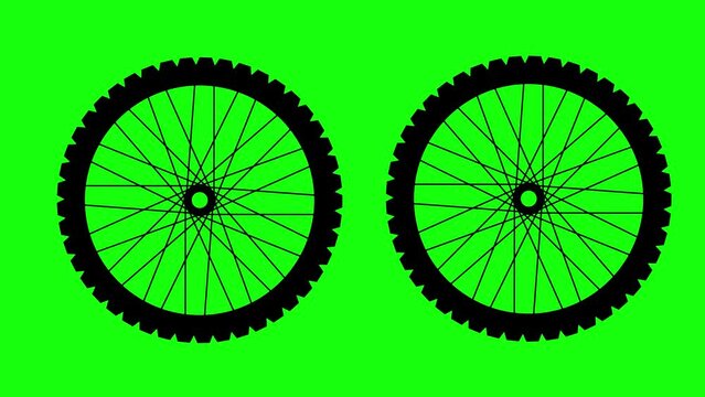 two spinning bicycle wheels on a chroma background. sport