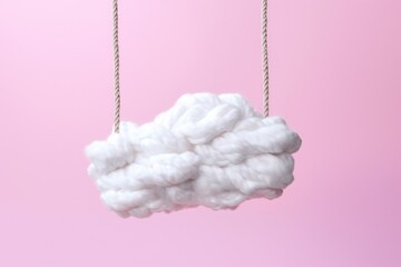 A white cotton cloud with a rope ladder going down on pink background Y2K style