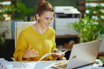 business owner woman in green office having virtual meeting