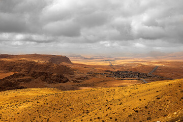 Top view of a canyon meandering through high sandstone mountains in the desert, Jordan