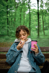 Girl with coffee and cake in the park