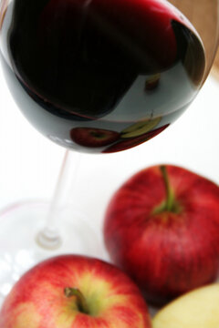 red wine in a glass with red apples