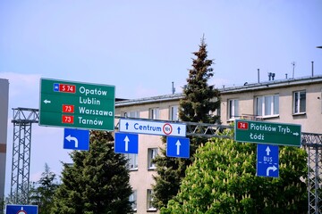 On road information board showing access which road to cities - Opatow Lublin Warsaw Tarnow , Piotrkow Trybunalski Lodz - obrazy, fototapety, plakaty