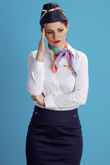 stressed modern flight attendant woman on blue