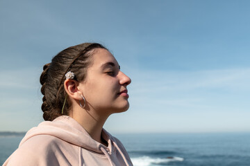 Portrait of a teenage girl with her eyes closed, profile photo