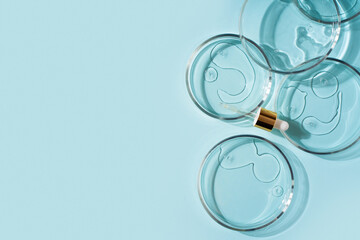Cosmetic beauty concept with bottle serum, drops and petri dish on blue background