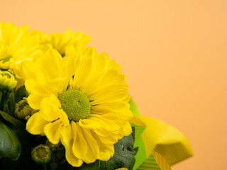 Bouquet of yellow daisies on an orange background. Yellow flowers.