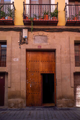 Fototapeta premium Stone building main entrance with a large open wooden door