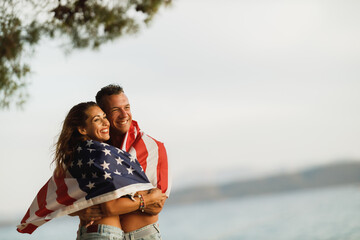 Couple In Embrace With American National Flag