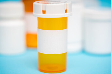 Amber prescription packaging for pills on a blue background