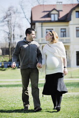 Fototapeta premium happy young married family couple outdoor in nature have fun and waiting baby and representing young family growth and pregnancy concept