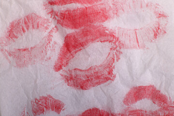 kiss prints with red lipstick on a sheet of notebook, background