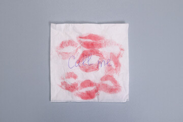 Napkin note with text call me and kisses