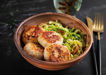 Zucchini spaghetti pasta  with chicken meatballs in bowl.