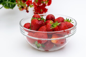 Red strawberries in glass bowl, fresh fruit for consumption