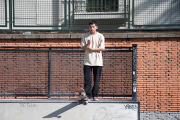 A teenage skateboarder jumps in a skate park. The concept of street sport and urban culture