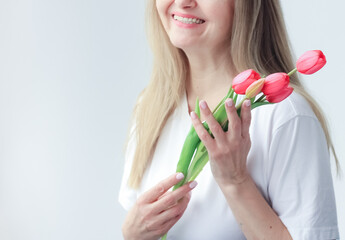 International Women's Day. Extremely happy woman is smelling a bunch of spring flowers. holiday, Mother's Day, Copy space
