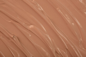 The base of the foundation is smeared as a sample background close-up. Makeup cosmetics. Concealer. Concealer texture.