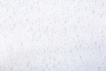 Soap foam close-up as a background. Facial cleanser foam bubbles. A foam party.