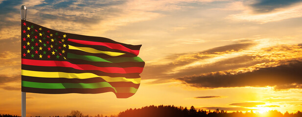 Alternative Juneteenth Flag on flagpole with sunrise or sunset. Since 1865. Banner with place for text.