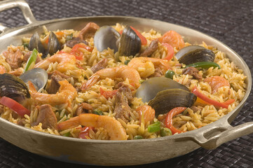 Seafood paella with shrimp, clams, and mussels over rice
