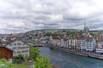 Fototapeta na wymiar Scenic view of the medieval old town of City of Zürich with Limmat River and quayside on a cloudy spring afternoon. Photo taken May 13th, 2023, Zurich, Switzerland.