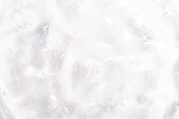 Cosmetic gel, serum transparent sample. Liquid cream with bubble texture. Gel texture of a cosmetic product. Clear liquid lotion for skin care.