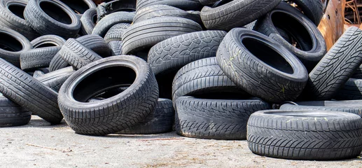 Industrial dump for the processing of used tires and rubber tires. Pile of old tires and wheels for rubber recycling. Tire dump. Recycling of used tires. Produced reclaimed tire rubber. © Yevhen Roshchyn
