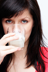 young beautiful causacian woman with glass of milk
