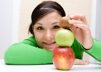 attractive brunette woman holding apple