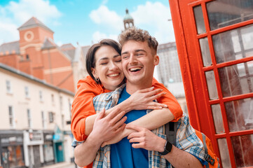 Outdoor portrait of couple  having a fun time in the city of England Enjoying travel concept