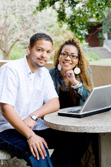 two african american college students study computer together