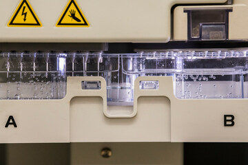 Detailed view of cathode buffer container on a sanger genetic analyser. Laboratory, DNA analysis,...