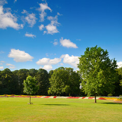 A beautiful city garden with flower beds and green lawns.