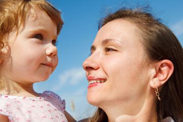 Mother looking at her pretty little daughter