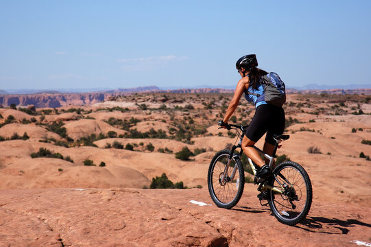 Female biker on slick rock in Moab, Utah