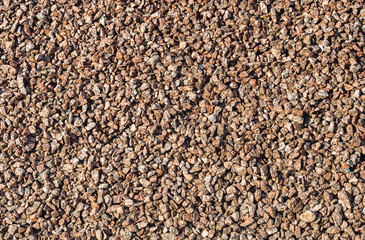 Brown small rubble. Stone gravel texture. Background. Top view close-up.