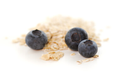 Blueberries and oats macro on white background