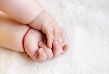 adorable cute baby boy infant toddler sleeping on bed blanket close up face parts small fat little hands,legs feet,barefoot child.new born in yellow bodysuit sweet dreams cute maternity big cheeks