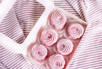 tasty delicious homemade zephyr pink marshmallows with blackberries taste.sweet dessert in box,on kitchen towel,gray tiles surface.whisk tea strainer accessories,sugar powder.pattern close up texture