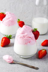 Whipped Strawberry Milk, Strawberry Milkshake, Dalgona Style Drink with Fresh Strawberry on Grey Background