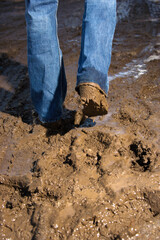 Close up shot of male walking through mud.