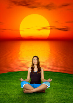 Beautiful woman making yoga at the sunset  (background digitally created)