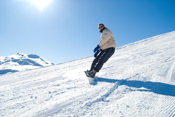 Fototapeta na wymiar Snowboarding on a mountain in a bright sunny day stock photo