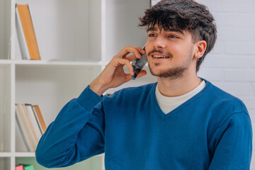 young man or student talking on mobile phone or smartphone