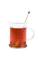 Cup of black tea with rock candy on white background