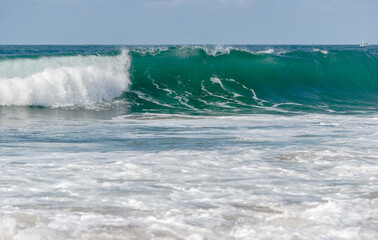 Naklejka premium Big Waves crashing creating white foam that vaporises in the air. Sopelana beach near Bilbao. Day of relaxation and tranquility with little wind and incredible colors.