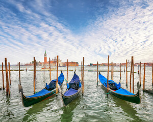 Obraz na płótnie Canvas Captivating landscape with Church of San Giorgio Maggiore on background and gondolas parked beside the Riva degli Schiavoni in Venice